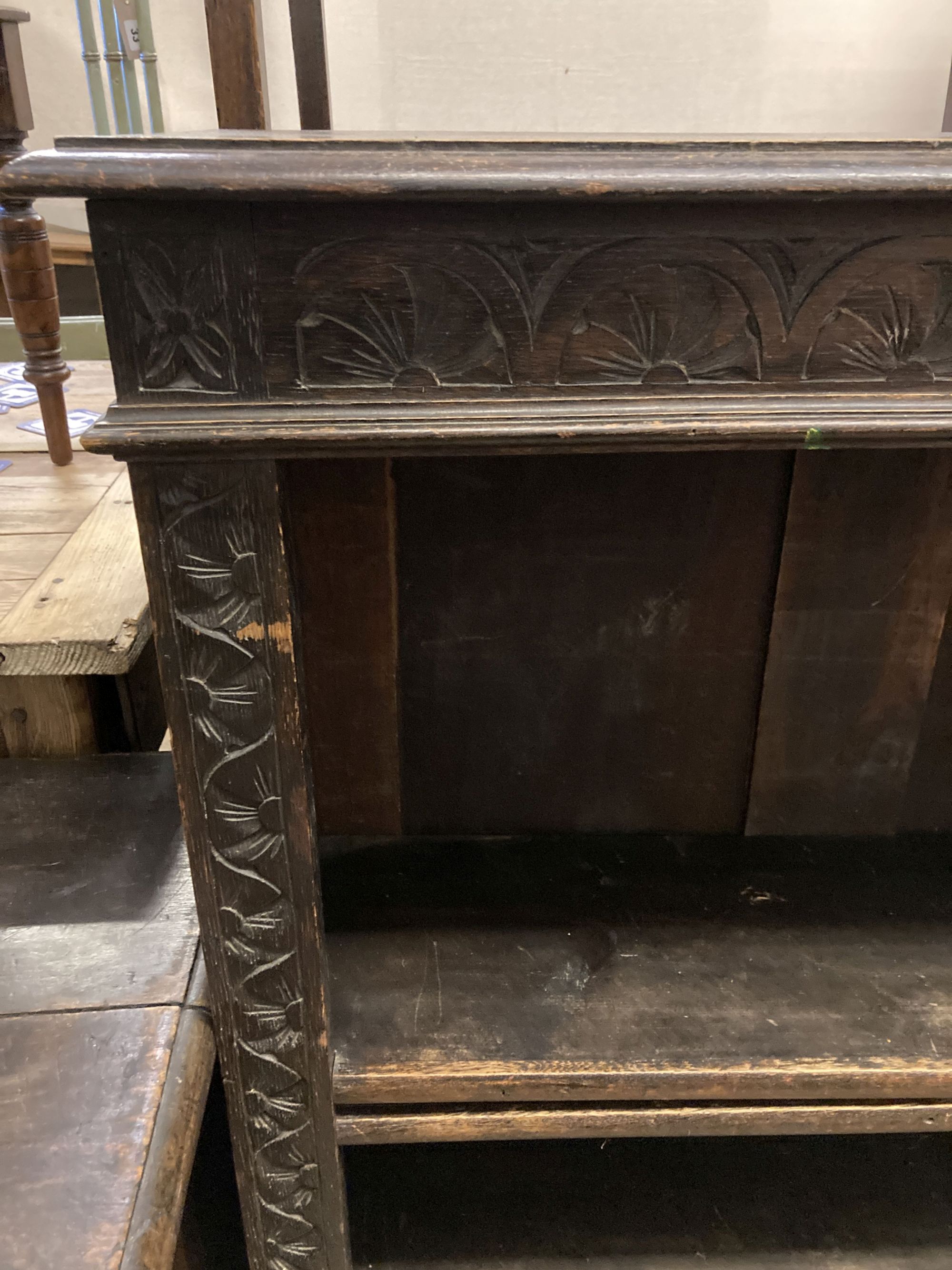 A late Victorian carved oak open bookcase, length 92cm, depth 31cm, height 115cm